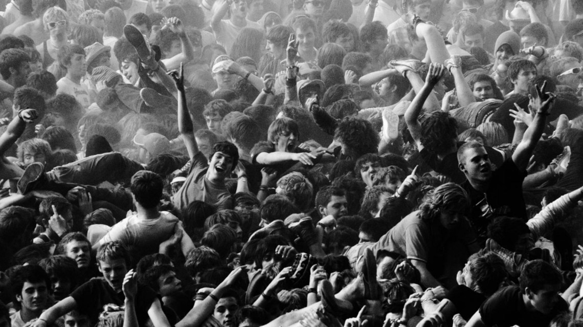 Crowd at a 90s themed rock festival with fans enjoying the show