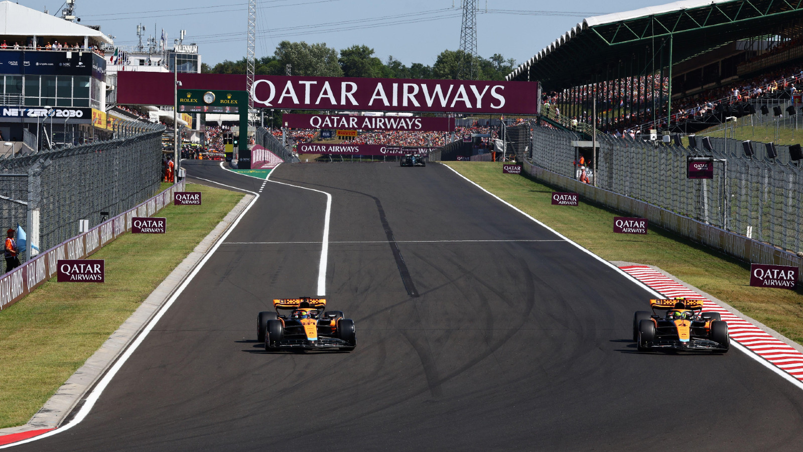 McLaren cars lined up in the pit lane, unable to start the Chinese Grand Prix due to unresolved technical issues