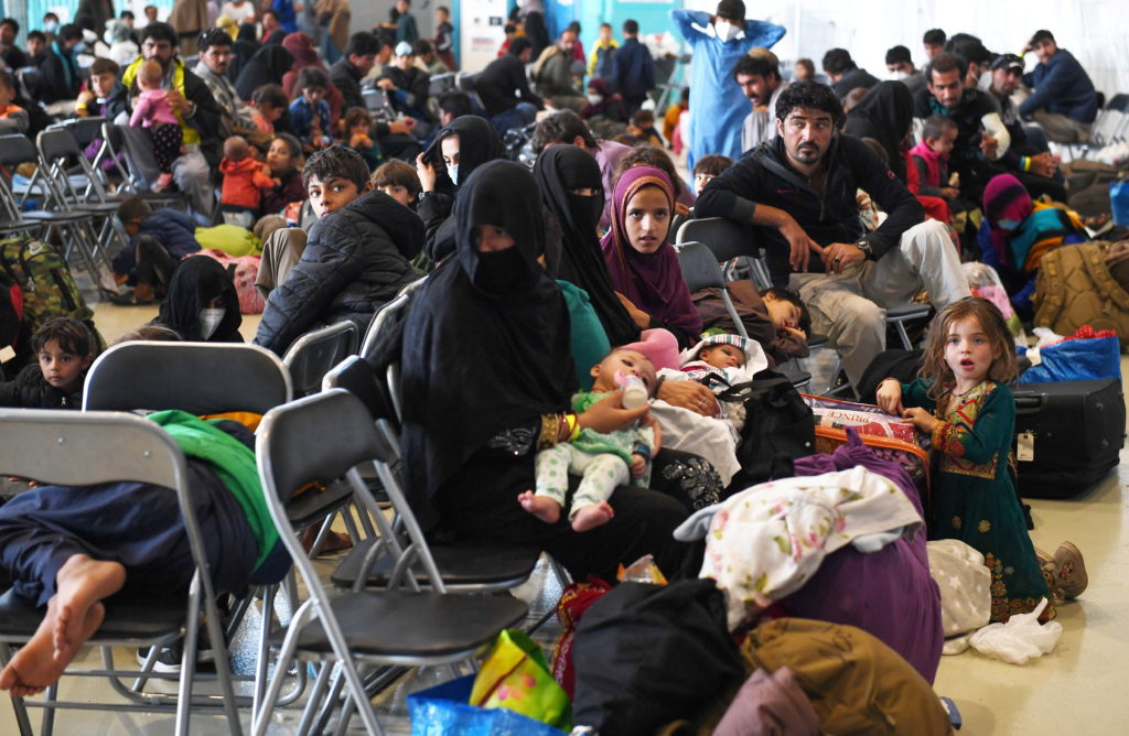 Afghan refugees waiting for US visa processing.