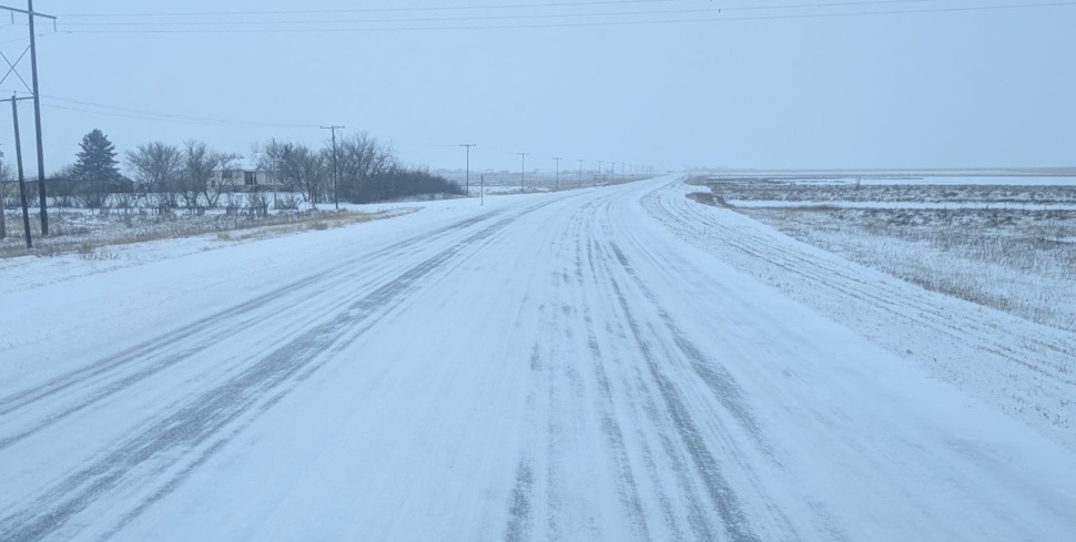 snow-covered highway in Saskatchewan during a winter storm